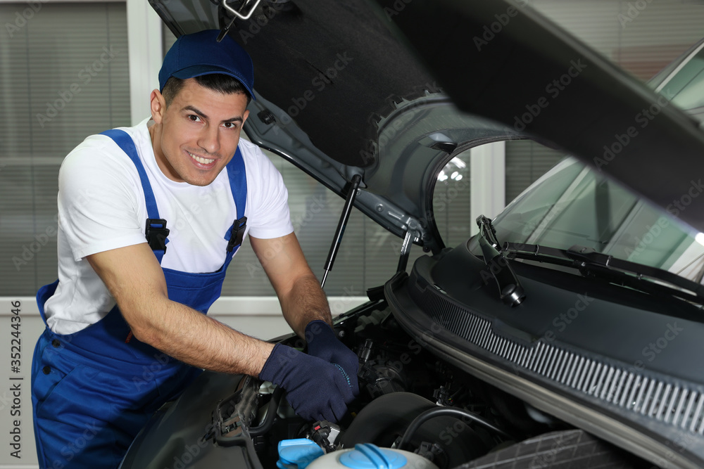 Mechanic fixing car at automobile repair shop Mechanic fixing car at automobile repair shop