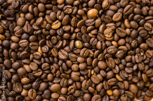 Lots of roasted coffee beans on a white background