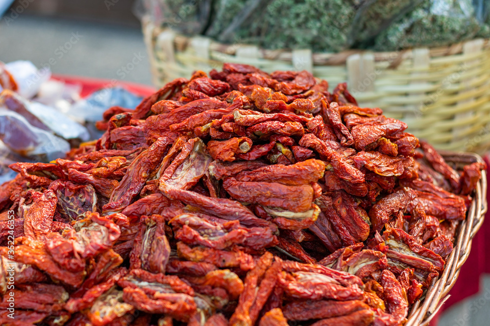 dried red tomatoes in a basket, closeup dried red tomatoes in a basket, closeup