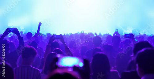 festival celebration Concert stage, crowd group people are visible waving and clapping, silhouettes Cheering crowd at a concert