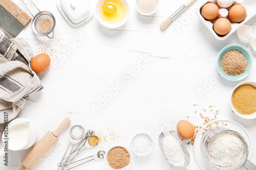 Fotografia, Obraz Baking homemade bread on white kitchen worktop with ingredients for cooking, cul