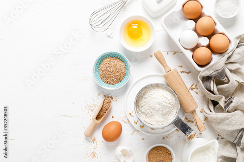 Fotografie Baking homemade bread on white kitchen worktop with ingredients for cooking, cul