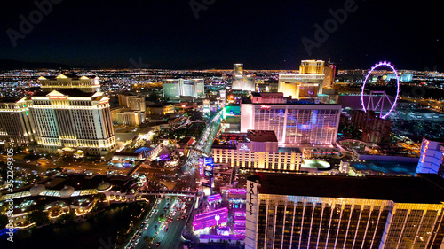 aerial panorama of Las Vegas Strip by night. Scenic flight over High Roller, Caesars Palace, The Paris, Planet Hollywood, Bellagio Casino and Hotel