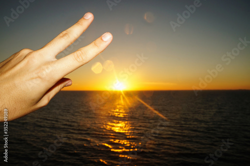 Peace and love symbol with sunset/sunrise on the ocean. Seen from a cruise   