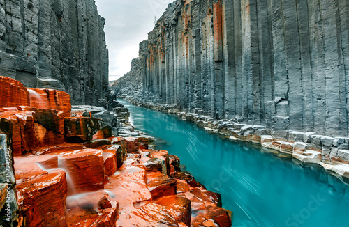  Wonderful Nature landscape. Incredible view on river in canyon with black basalt columns  under sunlight, Tipical Icelandic scenery. Studlagil Canyon during sunset. Iconic location for photographers. photo