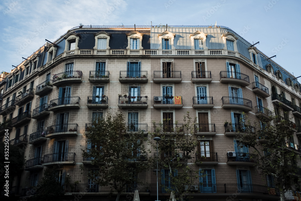 A beautiful building in Barcelona, Spain. The flag of Catalonia on the balcony. 