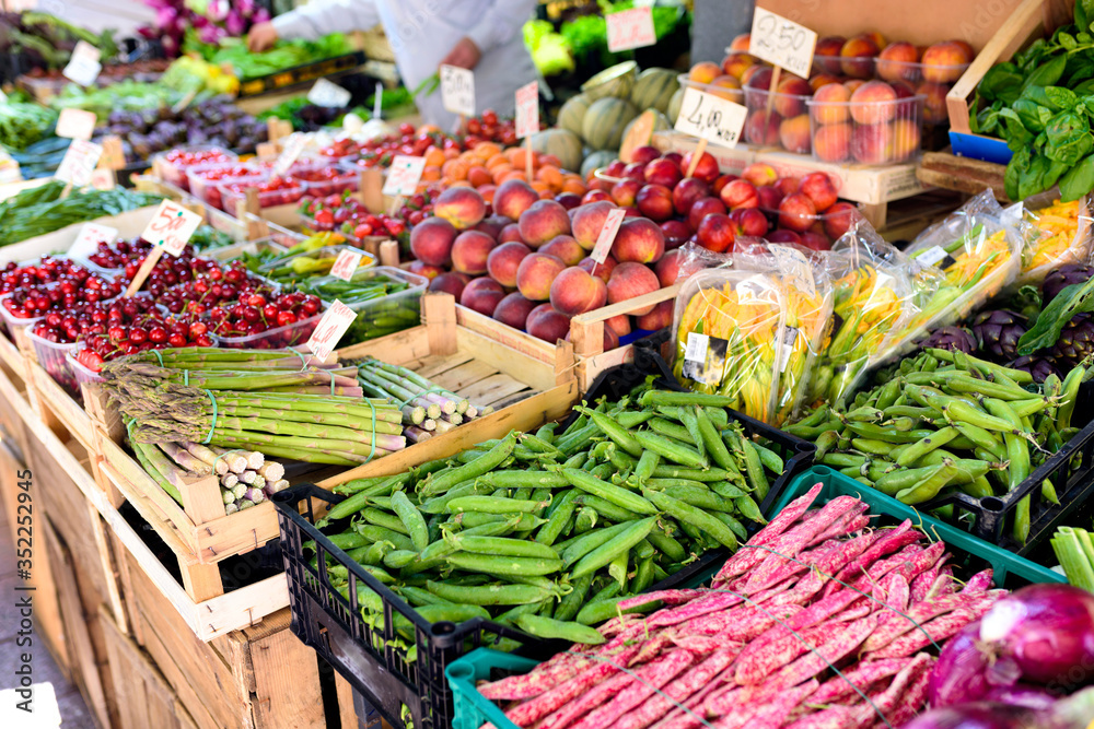 Fototapeta premium Traditional food market in the center of Bologna, Italy. Fresh vegetables and fruits on market stall. Selective focus.