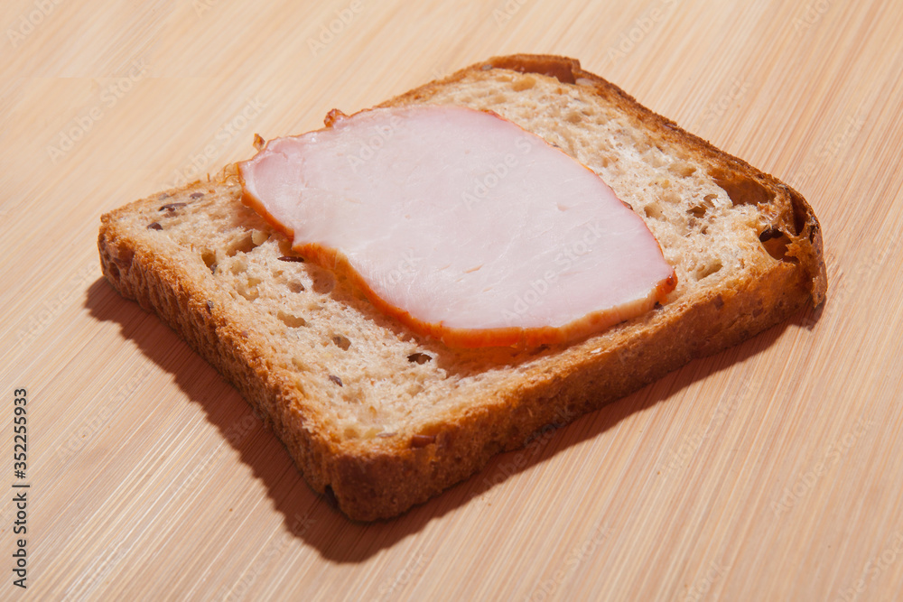 A simple homemade sandwich. Bread and ham A simple homemade sandwich. Bread and ham