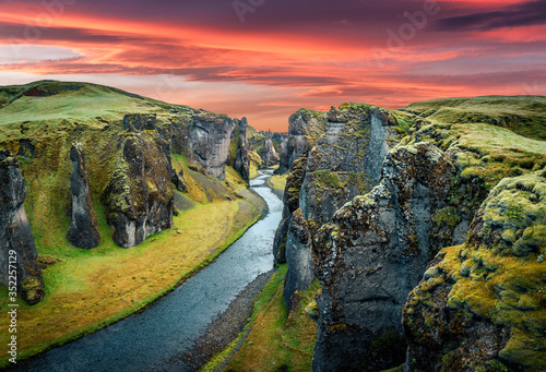Impressively beautiful nature of Iceland. majectic view on picturesque canyon Fjadrargljufur with colorful sky. Tipical Icelandic scenery during sunset. Iconic location for landscape photographers