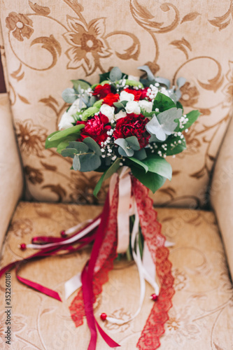 wedding bouquet in the hands of the bride and on the armchair, wedding details and shoes