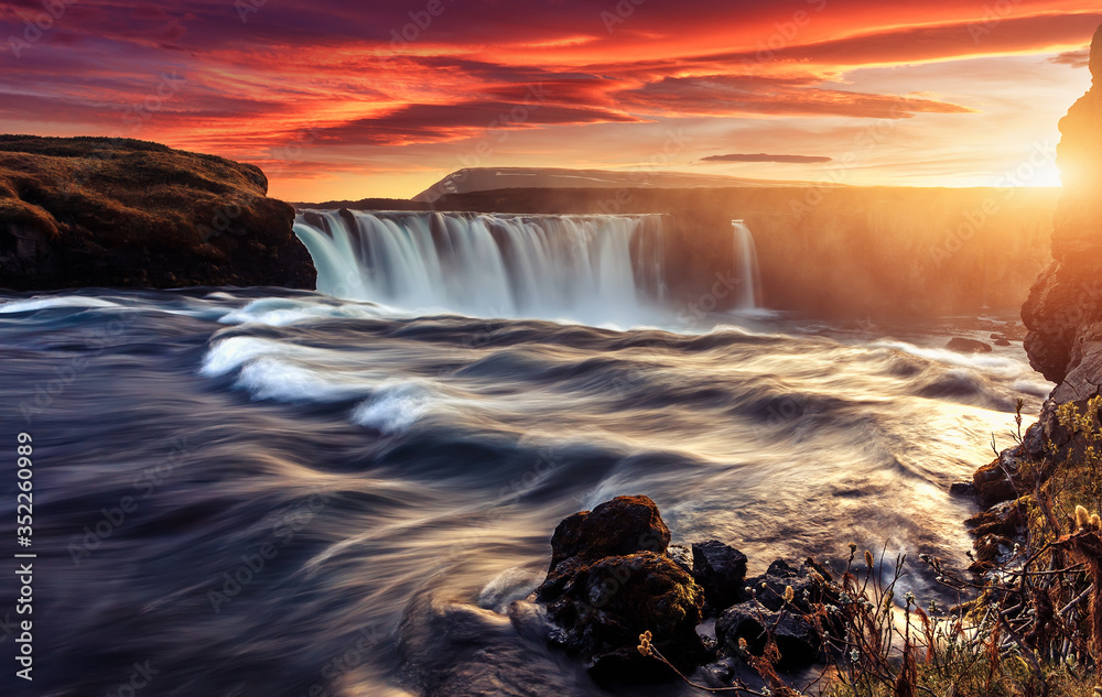 Obraz premium Scenic image of Iceland at sunset. Godafoss, One of the most famous waterfalls in Iceland. Amazing nature scenery. Iconic location for landscape photographers. Travel concept. Artistic Creative image.