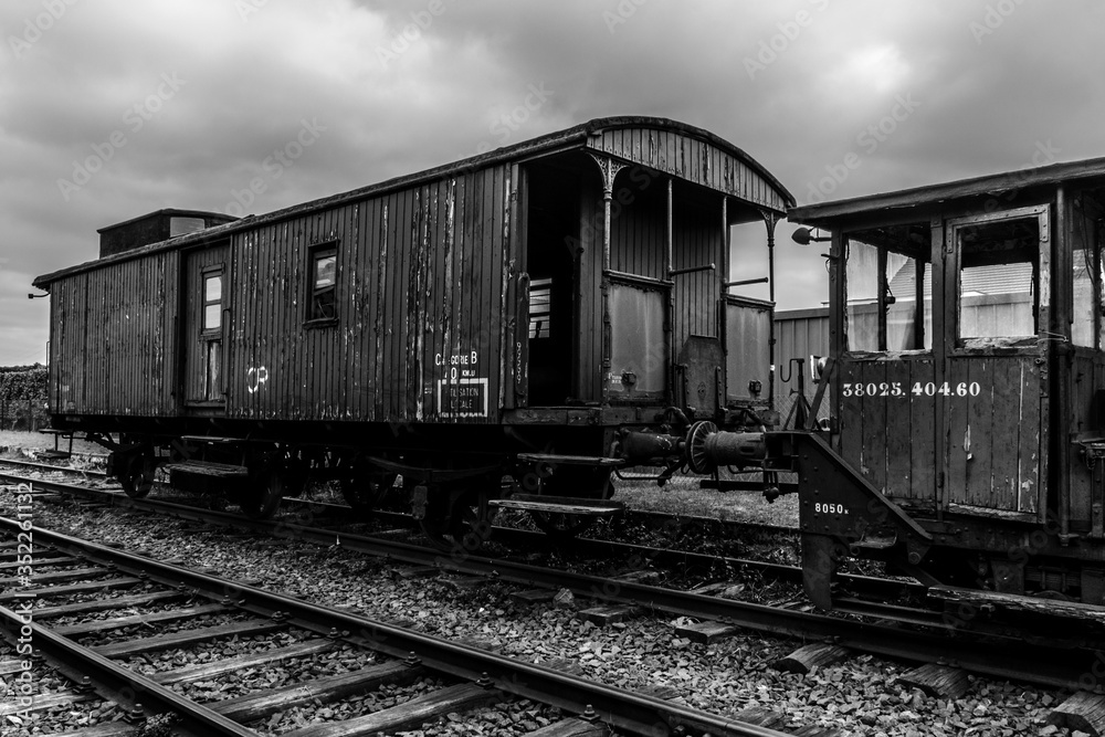 Old vintage wagon on the tracks, monochrome image