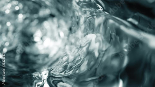 Water moves in a glass in slow motion photo