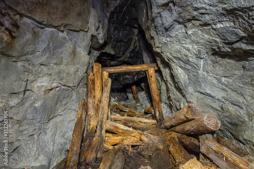 Underground old mica mine tunnel with collapsed wooden timbering