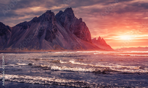 Impressive Colorful Seascape of Iceland. Wonderful picturesque Scene. Dramatic colorful sky glowing sunlit. Wonderful view of nature. Best popular places near Stokksnes cape and Vestrahorn Mountain.