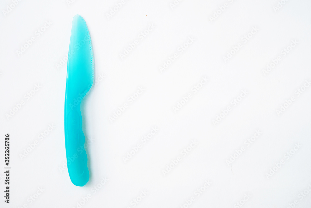 plastic knife blue white background top view