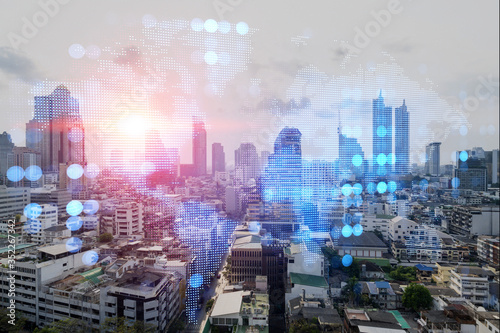Multi exposure of Bangkok cityscape day time and world map hologram. Concept of media networking.