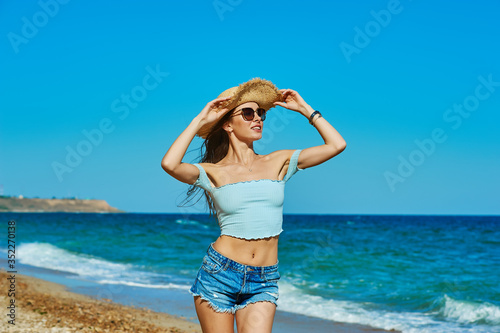 Two beautiful young women in sunglasses against a blue sky