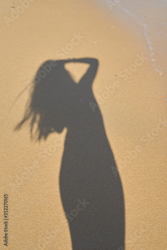 shadow from the photographer girl in the sand, silhouette in the sand,