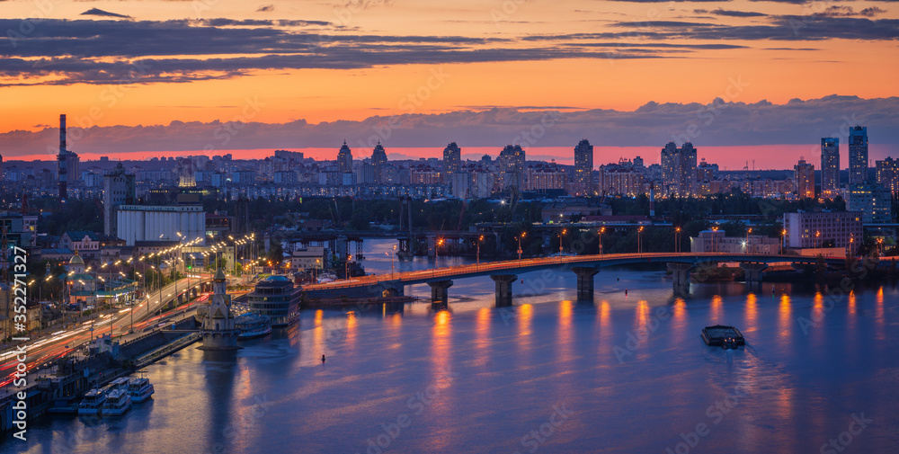 Beautiful clouds at sunset over Kyiv city with view from the Pedestrian Bridge.