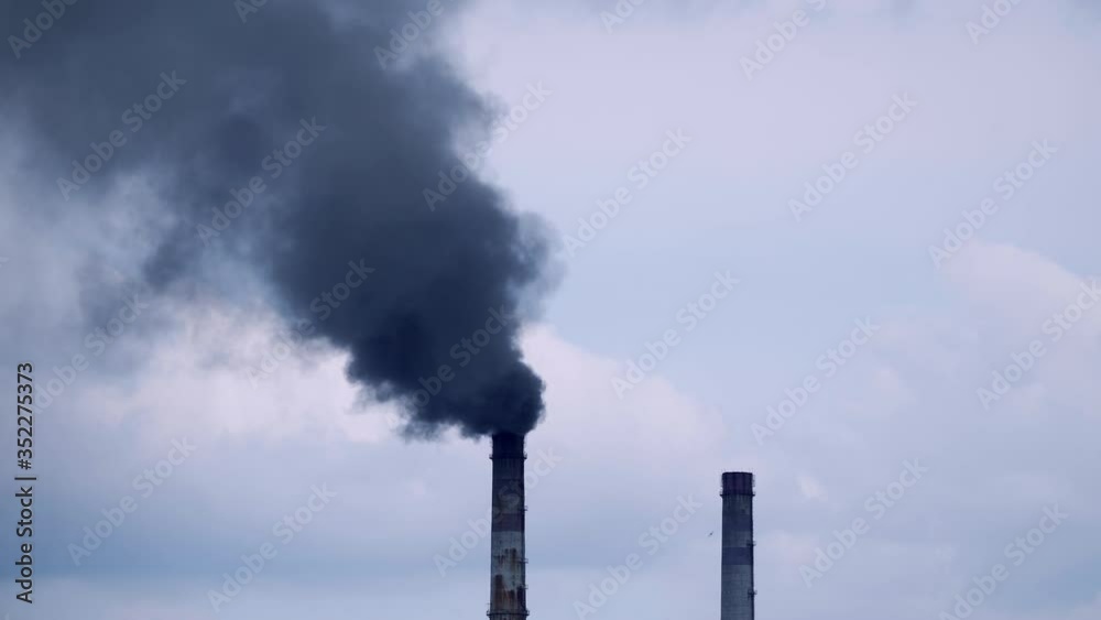 Factory pipe polluting air. Plant emits smoke and smog from the pipes