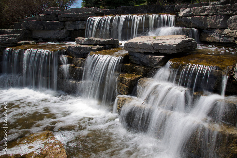 Fototapeta premium spring - flowing water - waterfall in the public park at Richmond Hill, Ontario, Canda
