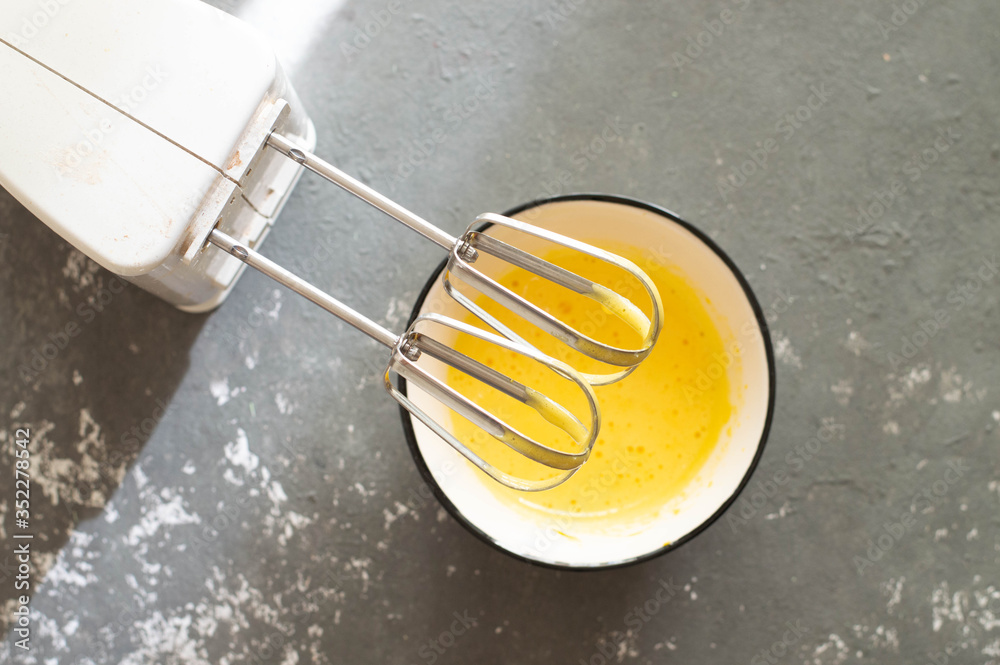  kitchen mixer whisk dough made from egg yolk and flour.