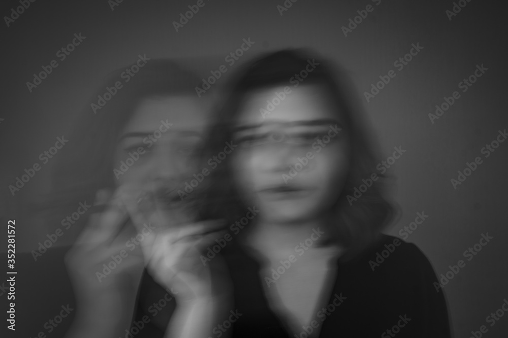 girl with artistic grease stands on a gray background in her teeth holds a cigarette girl with artistic grease stands on a gray background in her teeth holds a cigarette