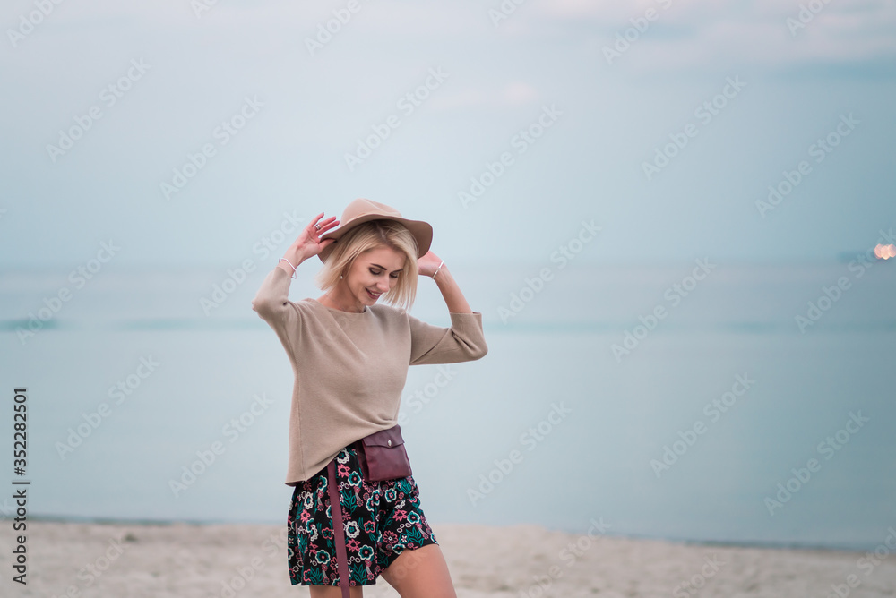 A beautiful young girl walks along the seashore and enjoy the rest. A beautiful young girl walks along the seashore and enjoy the rest.