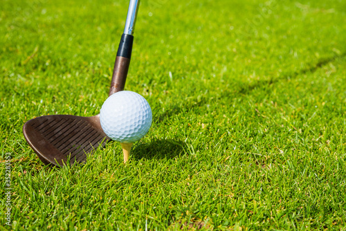 golf ball ang club on golf green grass natural fairway