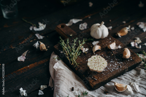 Thyme,  garlic on a brown wooden board. farm products, organic products, Healthy food concept