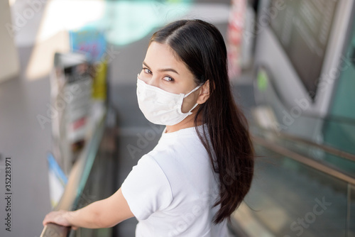 young woman with mask standing outdoor