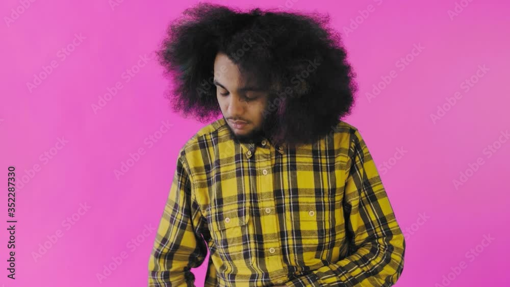 African American man received a new message on his phone on purple background. Concept of emotions African American man received a new message on his phone on purple background. Concept of emotions