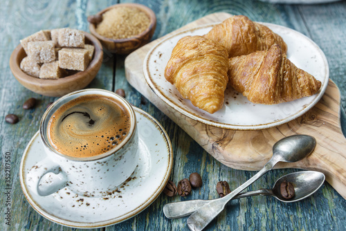 Cup of black coffee and cro...