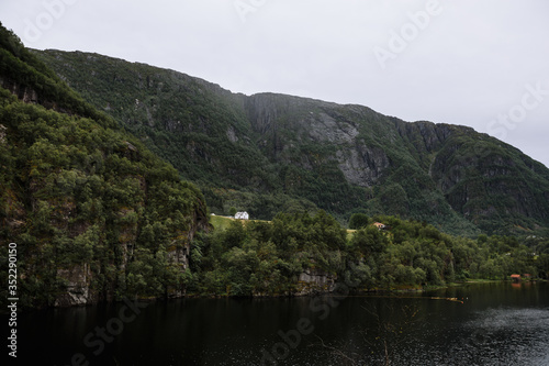 Norwegian landscape. Village house standing on a rock