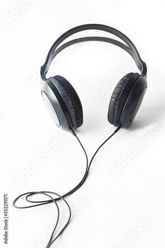 White background. On it are headphones for listening to music, black. Close-up