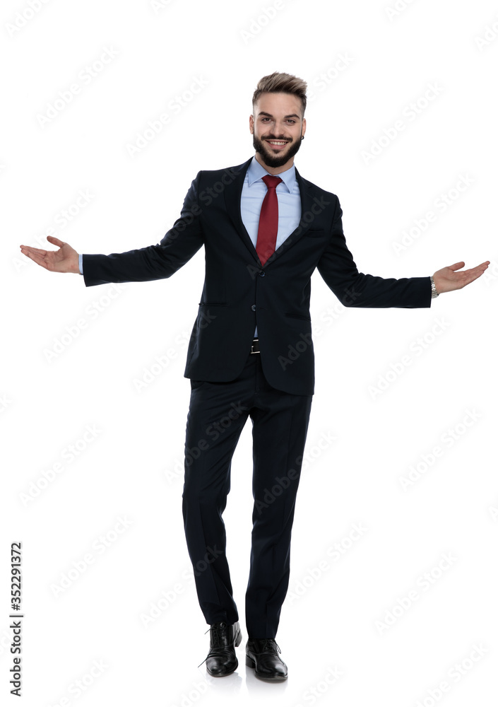 happy young guy in suit walking and opening arms happy young guy in suit walking and opening arms