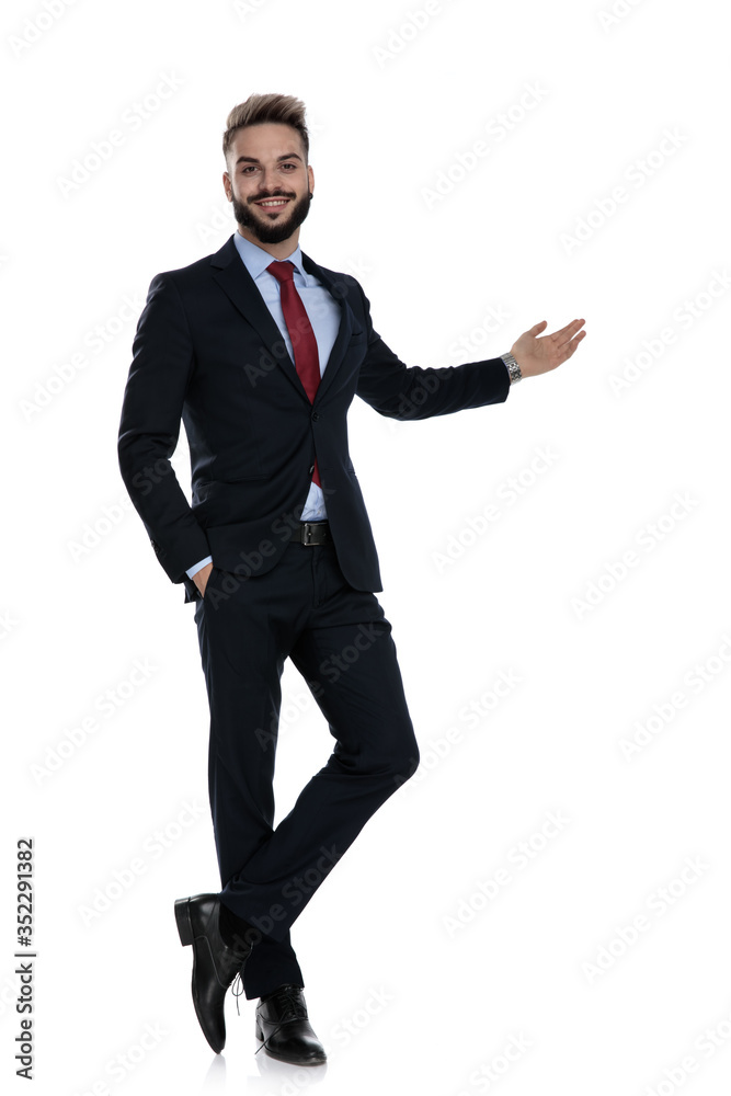 smiling young businessman presenting to side