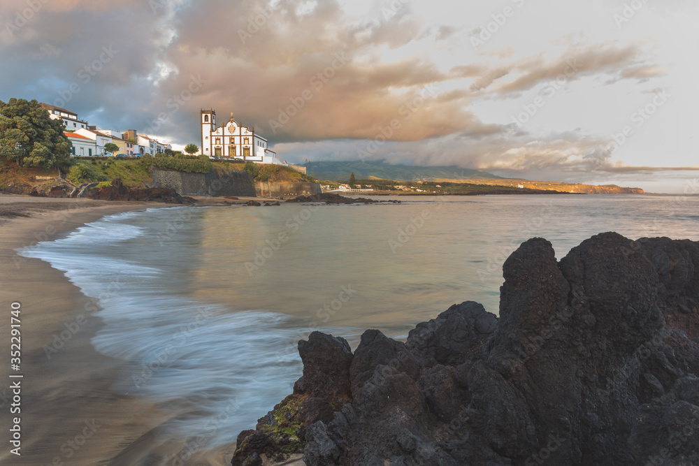 Portugal, Azores, Sao Miguel Island, Sao Roque. Beach view with town church
