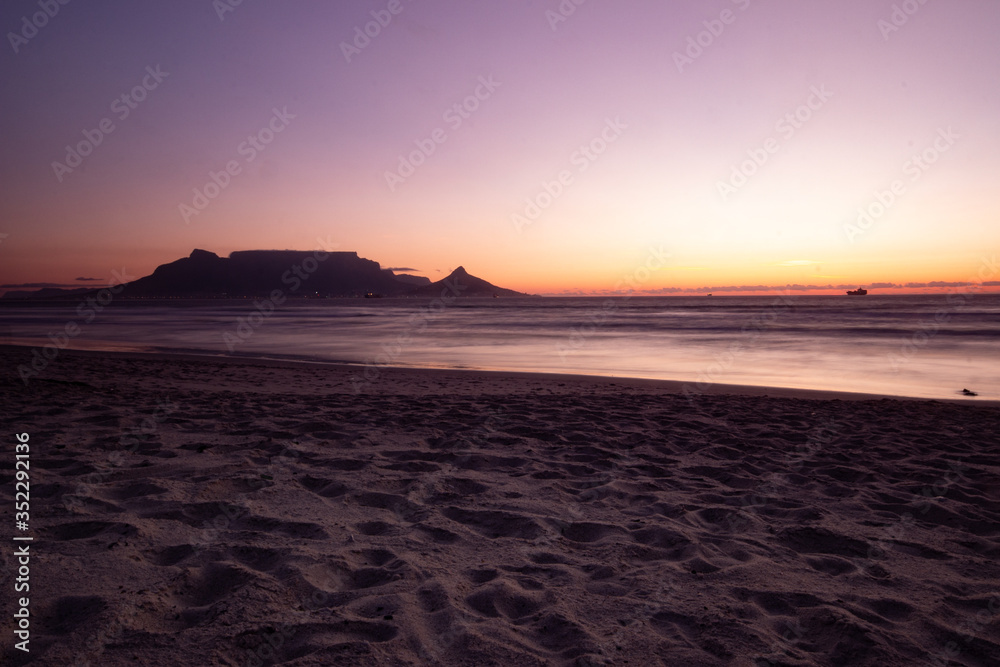 sunset at the beach with Table Mountain in background sunset at the beach with Table Mountain in background
