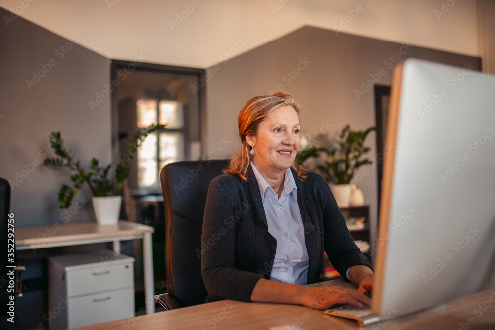 Mature woman using computer, portrait. Mature woman using computer, portrait.