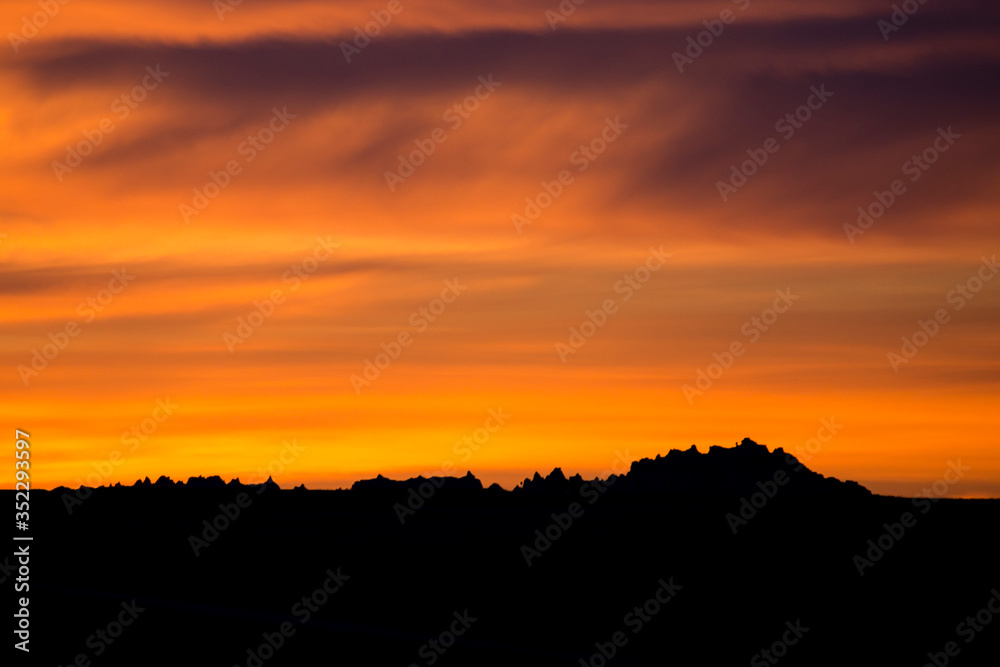 Landscape view of a colorful sunset in Badlands National Park in South Dakota). Landscape view of a colorful sunset in Badlands National Park in South Dakota).