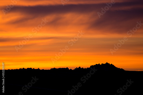 Landscape view of a colorful sunset in Badlands National Park in South Dakota .