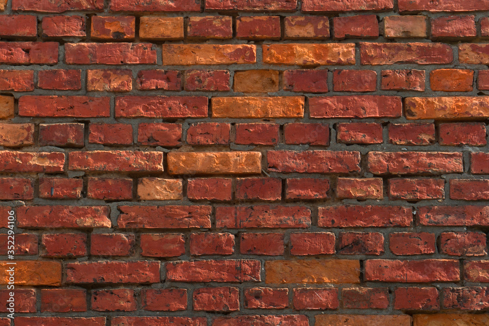 old, frayed yellow brick wall texture, background