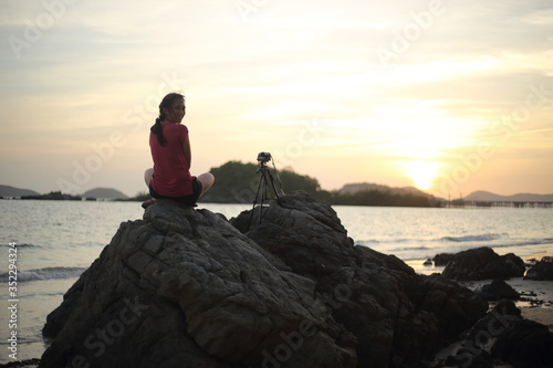 Women wait photography sunset at the beach