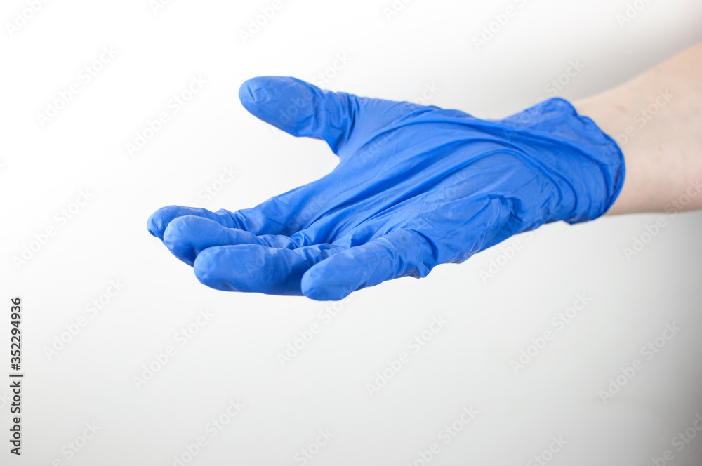 Shot of a doctor hand шт blue medical glove with palm up on a white background Shot of a doctor hand шт blue medical glove with palm up on a white background