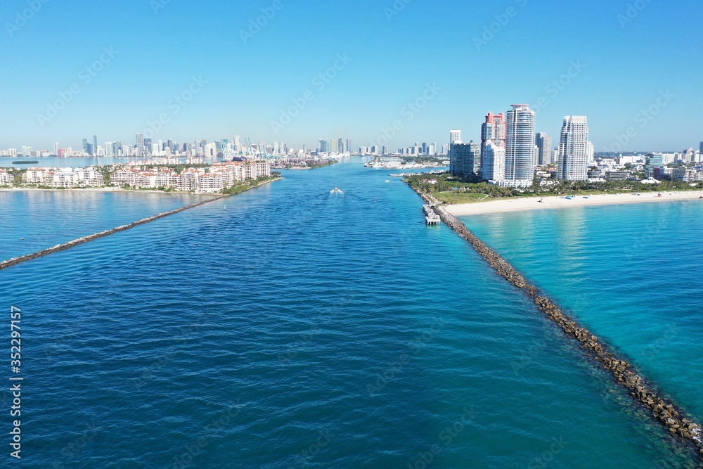 Aerial view of Fisher Island, South Pointe and Government Cut with City of Miami skyline and Port Miami in background. Aerial view of Fisher Island, South Pointe and Government Cut with City of Miami skyline and Port Miami in background.