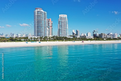 Aerial view of beachfront residential buildings on South Pointe in Miami Beach, Florida on tranquil clear sunny morning.