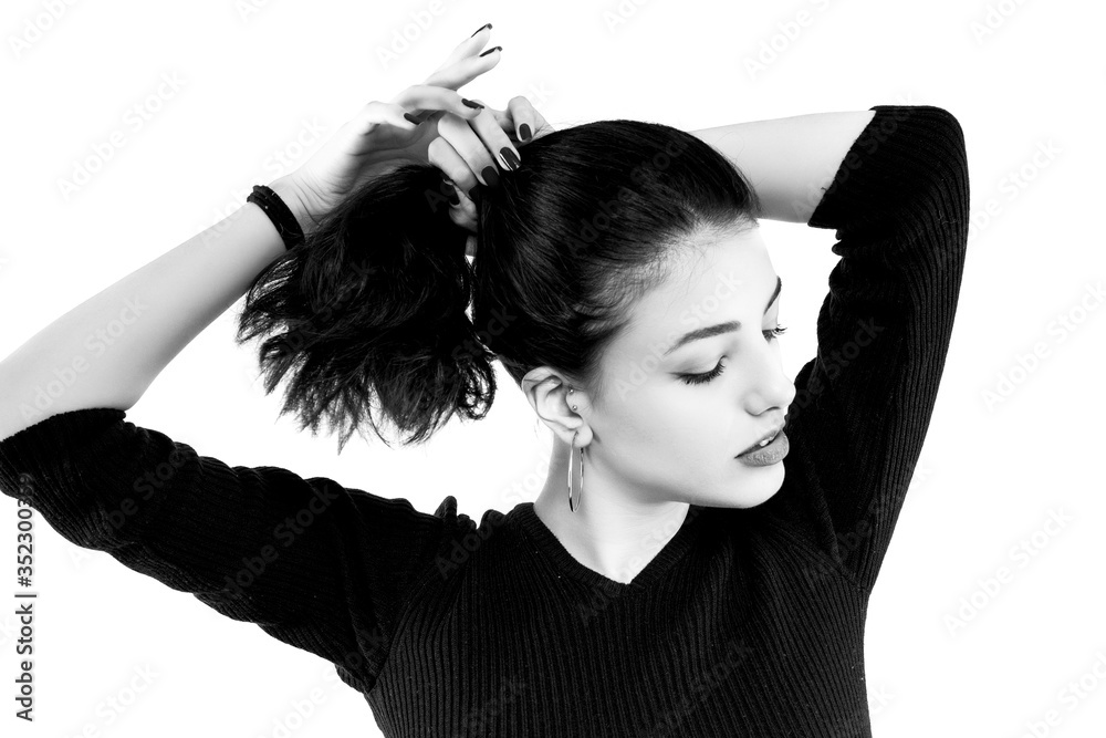 Φωτογραφία Black and white brunette girl holding her black hair isolated on white background