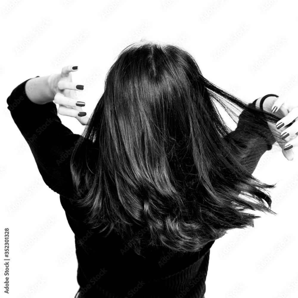 Fototapeta premium Black and white brunette girl holding her black hair isolated on white background. Portrait of beauty girl.